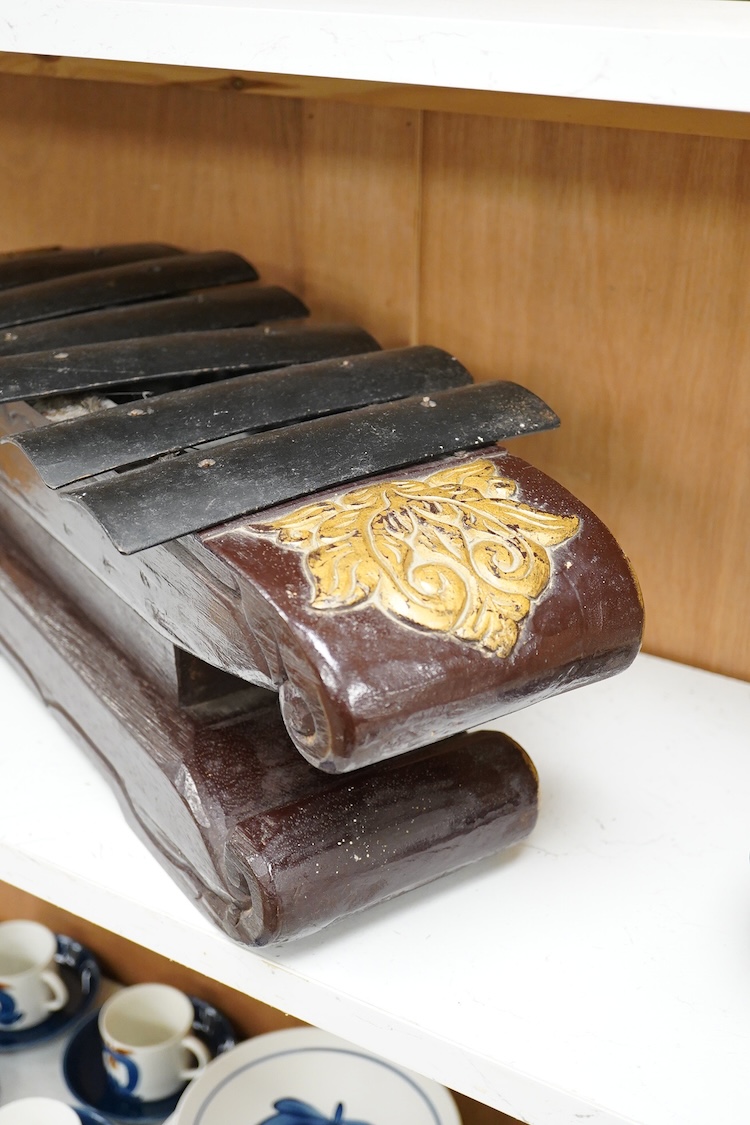 A carved and gilt Balinese Gamelan, 60cm
